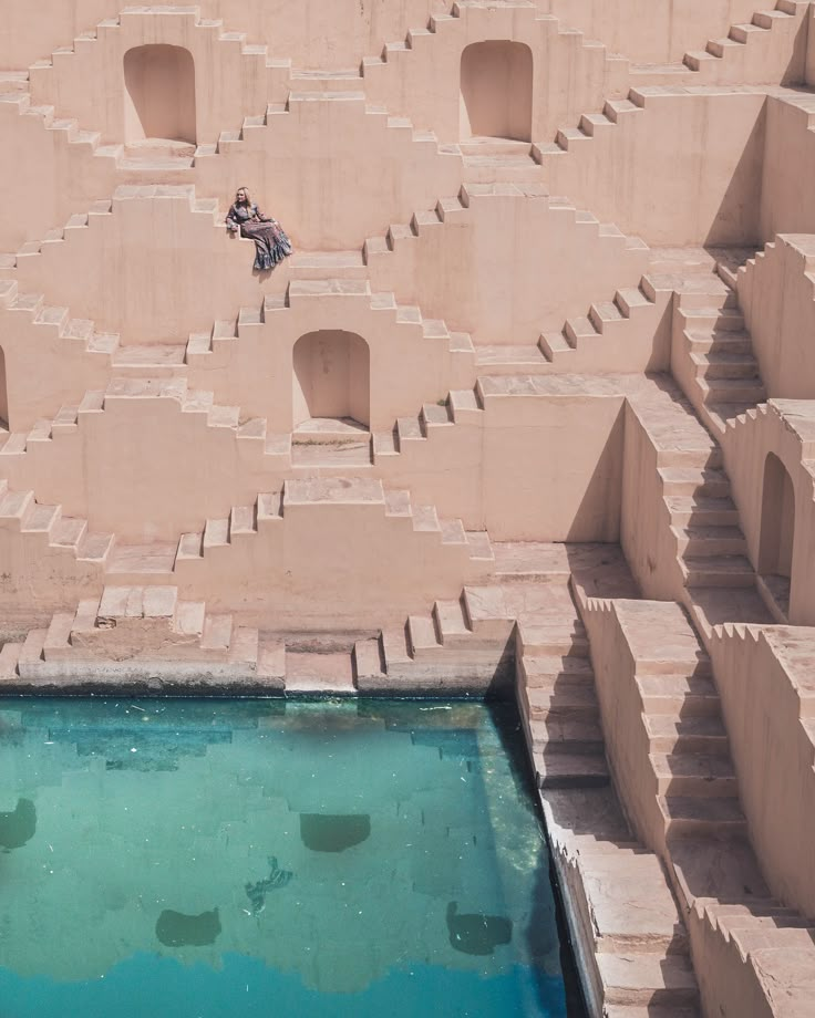 an aerial view of a building made out of concrete blocks with a pool in the middle