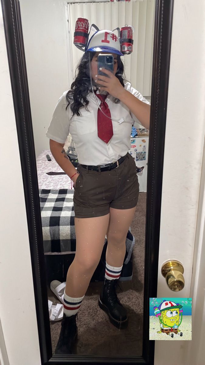 a woman dressed in shorts and tie taking a selfie