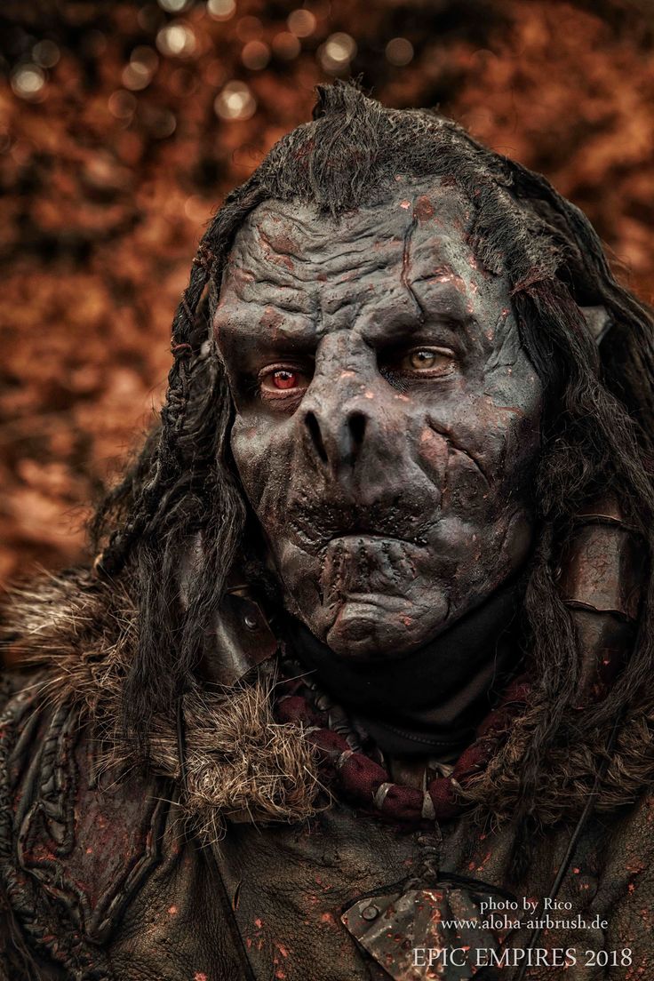 a close up of a person with long hair and blood on it's face