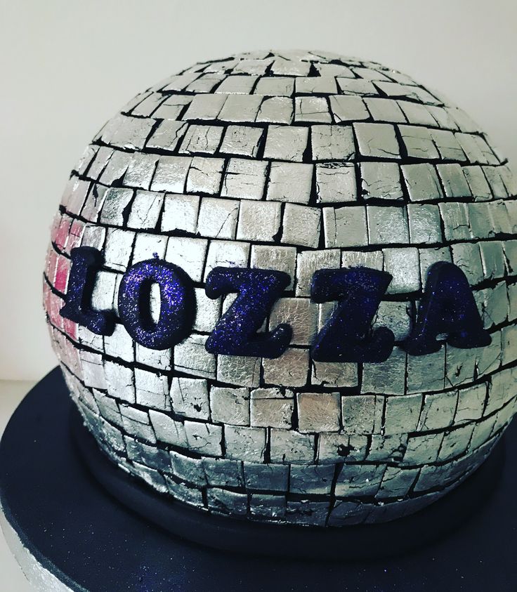 there is a cake that has been made to look like a disco ball with the word 707 on it