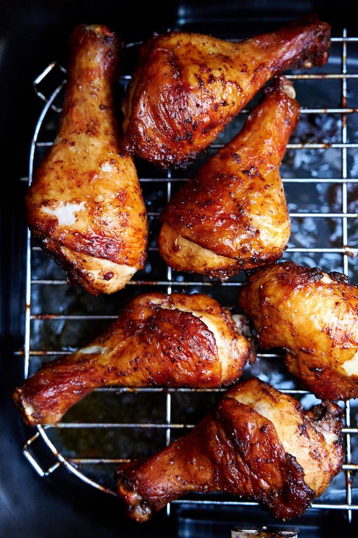 chicken legs cooking on the grill in an air fryer