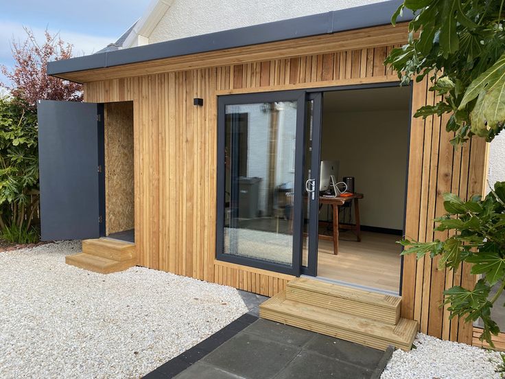 a small wooden building with sliding glass doors