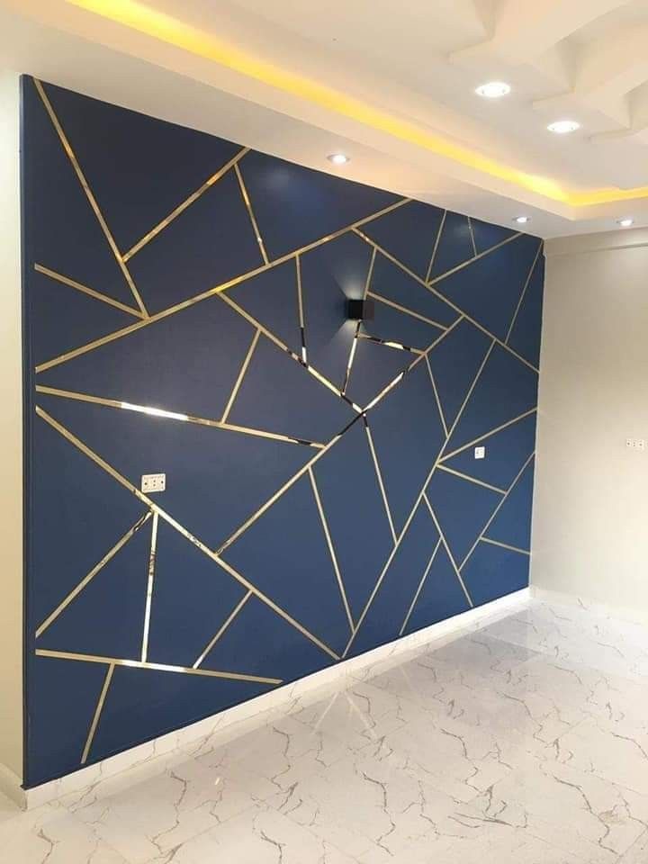 a large blue wall with gold lines on it