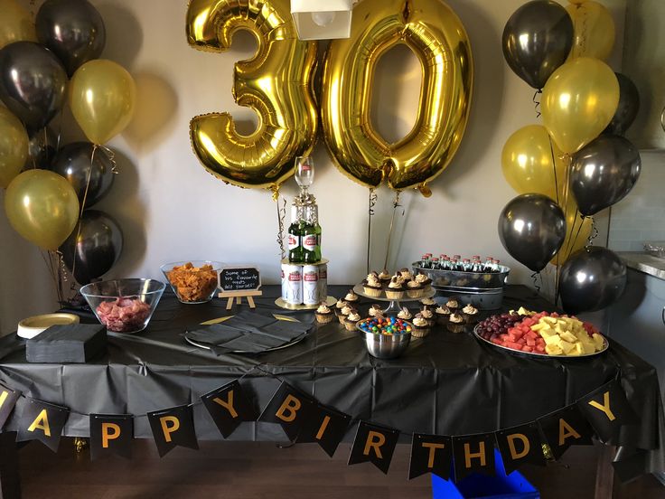 a 50th birthday party with balloons and desserts