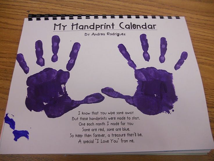 a purple handprint calendar on a wooden table