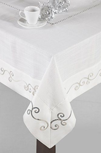 a white table cloth with silver trimmings and a coffee cup on the side