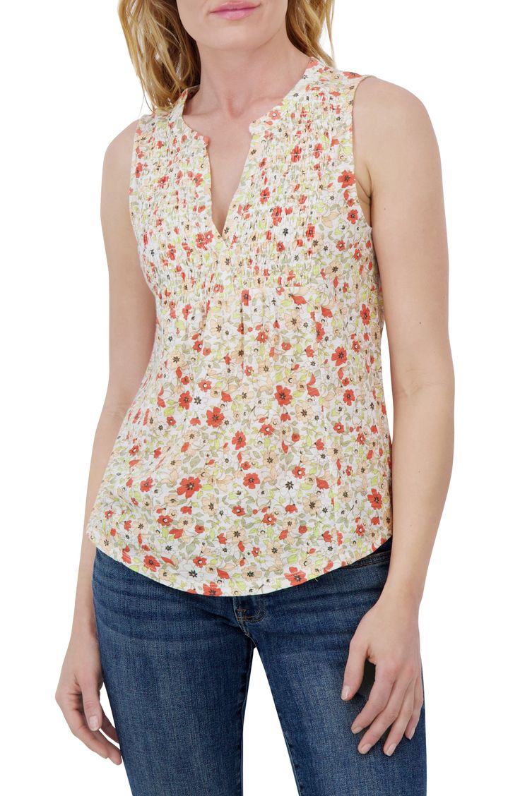 Dainty flowers blossom along a sleeveless tank styled with a smocked notched collar. Notched collar Sleeveless 60% cotton, 40% polyester Machine wash, tumble dry Imported Spring Sleeveless Tops With Smocked Back, Sleeveless Smocked Back Tops For Spring, Sleeveless Tops With Smocked Back For Spring, Sleeveless Printed Tops For Daywear, Printed Sleeveless Tops For Daywear, Spring Sleeveless Top With Smocked Bodice, Casual Floral Print Smocked Top For Daywear, Sleeveless Top With Smocked Bodice For Spring, Sleeveless Smocked Top For Spring