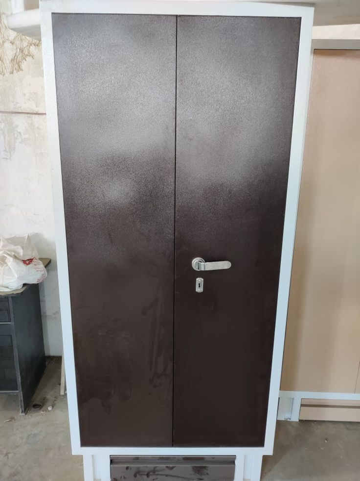 a large brown cabinet sitting inside of a room