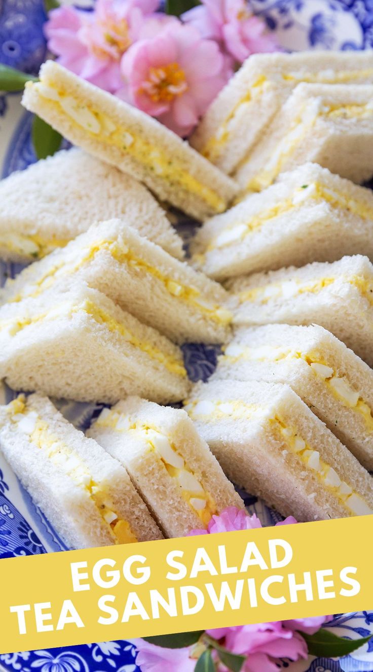 egg salad tea sandwiches on a blue and white plate with pink flowers in the background