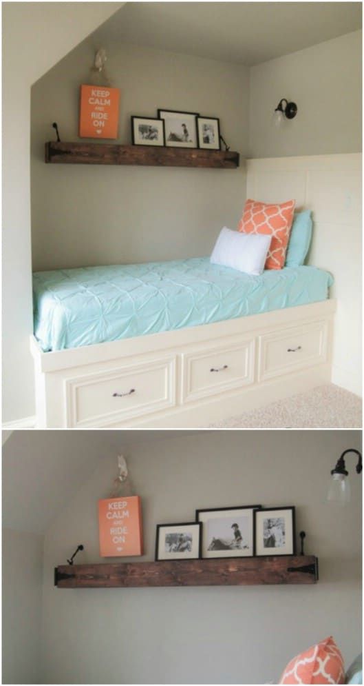 there are two shelves above the bed with pictures on them and one shelf below it