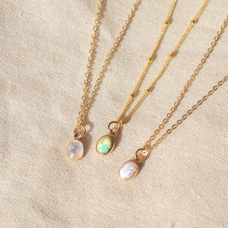 Our Dainty gemstone necklace features a tiny little stone, choose between opal, moonstone and turquoise. …………………………………. Details: Pendant is Genuine Turquoise, Genuine Moonstone, or Synthetic Opal, measuring 5 x 7mm Available in 14k Gold Filled or Sterling Silver Waterproof and can be worn everyday Average necklace length is 18" About Your Jewelry If you are not wearing your jewelry it is best to store it in a cool, dry place such as your gift box that is included in your order. Everyday Opal Jewelry With Gemstones, Everyday Opal Gemstone Jewelry, Bohemian Moonstone Birthstone Necklace, Opal Jewelry With Delicate Chain As Gift, Delicate Opal Chain Jewelry As Gift, Delicate Opal Chain Jewelry Gift, Delicate Opal Chain Jewelry For Gifts, Dainty Moonstone Charm Necklace For Gift, Moonstone Birthstone Necklaces For Jewelry Making