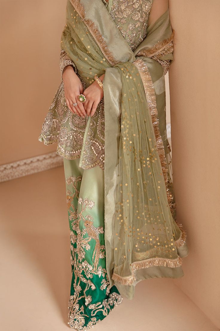 Mint Green Wedding Dress Pakistani in Peplum Style is an elegant attire that is hand-crafted with luxury details and embellishments. Premium quality fabric and a lavish blend of colors make this beautiful Pakistani Wedding Dress your priority for the big day. Pakistani Peplum The beautiful peplum comes in an alluring mint green shade and it has premium organza fabric. Beautiful silverwork and shimmering ornaments enhance the glamour of the perfectly stitched Peplum frock. Pakistani Trouser The e Green Wedding Dress Pakistani, Mint Green Wedding Dress, Wedding Dress Pakistani, Green Wedding Dress, Mint Green Wedding, Wedding Dresses Pakistani, Dress Pakistani, Wedding Mint Green, Green Wedding Dresses