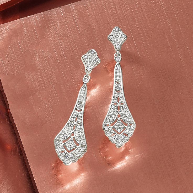 Ross-Simons - .15 ct. t. w. Diamond Openwork Drop Earrings in Sterling Silver. Jazz up your look with our embellished pair. The sterling silver vintage-style designs glitter with .15 ct. t. w. diamonds, boasting intricate openwork. Hanging length is 1 1/2". Post/clutch, diamond openwork drop earrings. Diamond birthstones are the perfect gift for April birthdays. Classic Chandelier Earrings With Diamond Accents For Evening, Classic Elegant Diamond Earrings For Party, Elegant Silver Chandelier Earrings With Sparkling Stones, Glamorous Silver Sparkling Diamond Earrings, Formal Silver Sparkling Crystal Earrings, Classic Crystal Bridal Earrings For Evening, Sparkling Silver Crystal Earrings For Formal Events, Classic Evening Bridal Earrings In Crystal, Classic Silver Chandelier Earrings With Diamond Accents