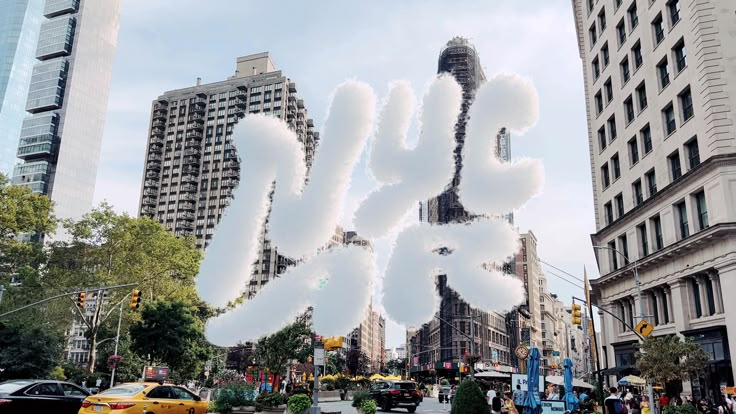 there are many clouds in the shape of letters on this city street with tall buildings