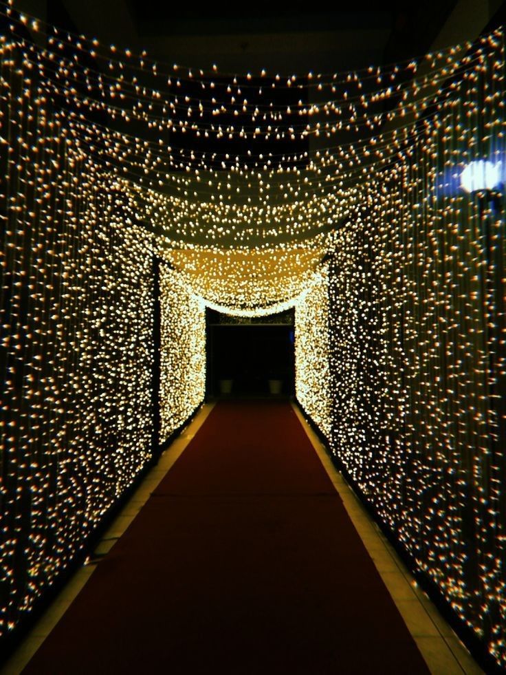 a long hallway with lights all over it