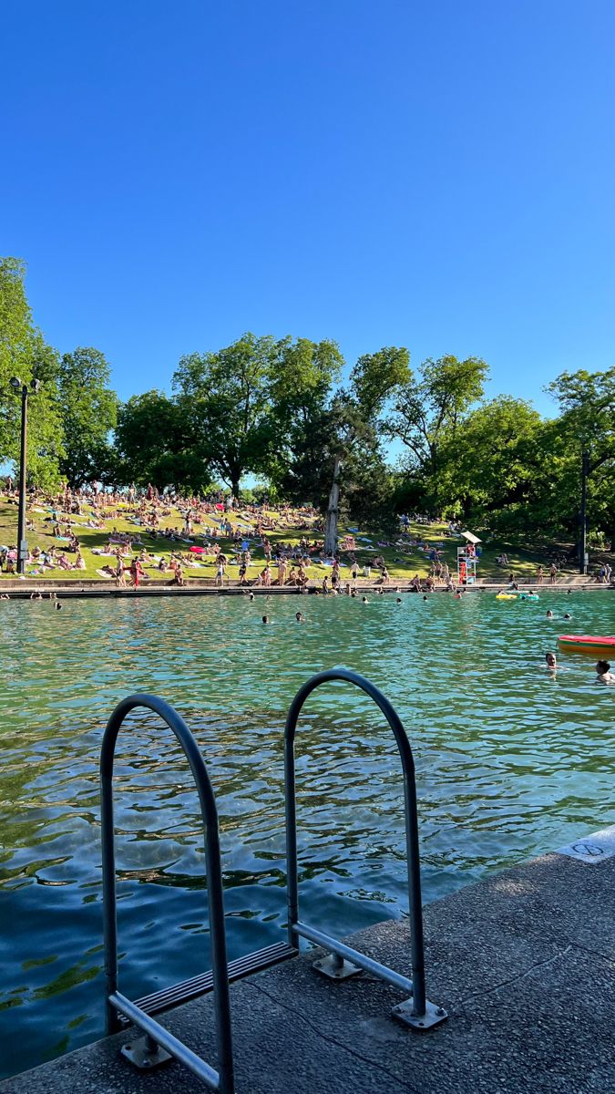 people are swimming in the water at a park