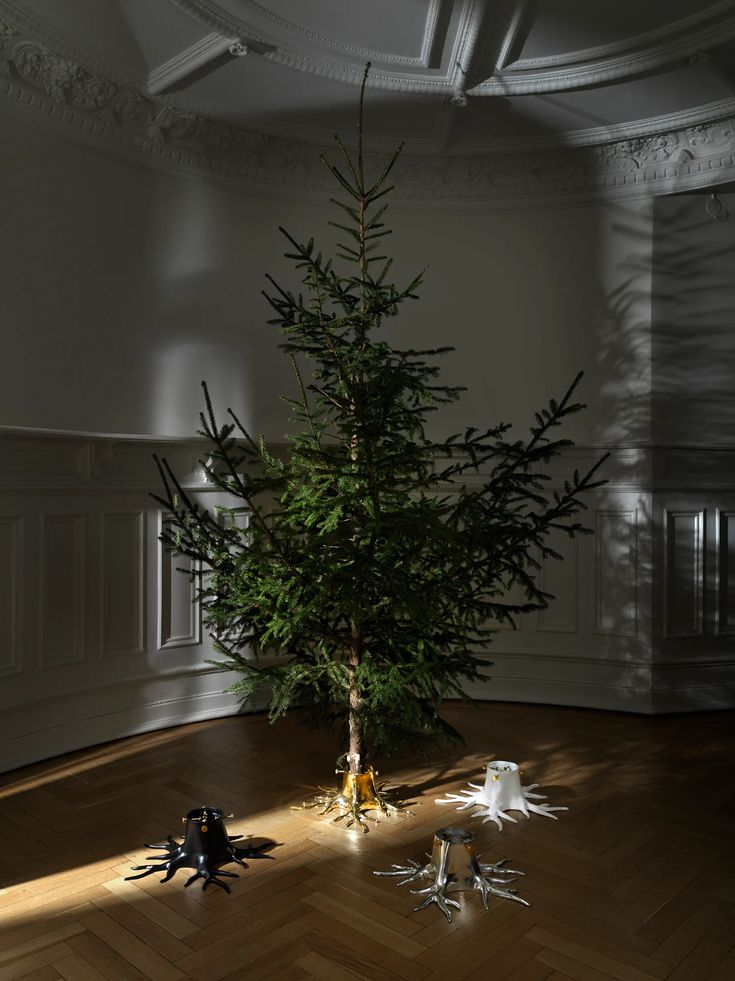 a small christmas tree sitting on top of a wooden floor