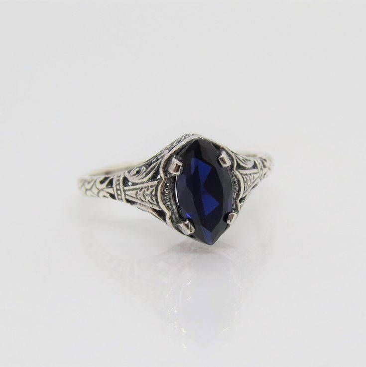 Sterling Silver Blue Sapphire Filigree Ring ....Marked 925...Total of weights 2.1grams..Size 10...Measure of Face 10.1MM...It's in very good condition. Mens Blue Topaz Rings, Sapphire Engagement Ring Men, Antique Sapphire Ring In Blue, Heirloom Blue Sapphire Ring Hallmarked, Collectible Blue Sapphire Ring Hallmarked, Sterling Silver Sapphire Ring Stamped 925, Classic Sapphire Ring Collectible, Collectible Hallmarked Blue Sapphire Ring, Classic Sapphire Rings For Collectors