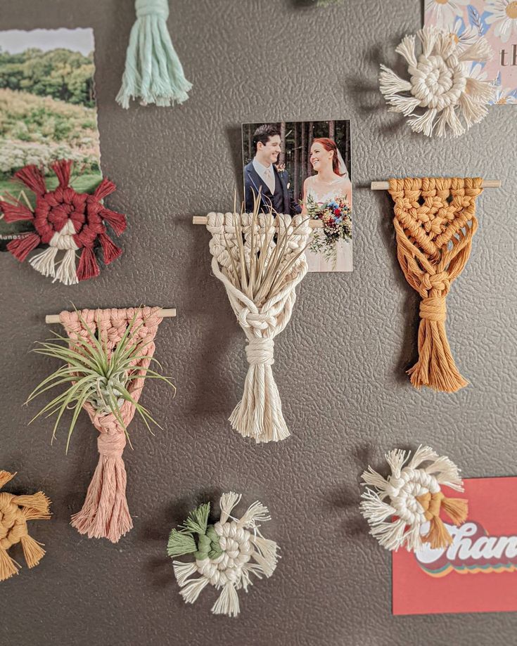 the wall is decorated with many different types of flowers and pictures on it, including one of them hanging from a cross