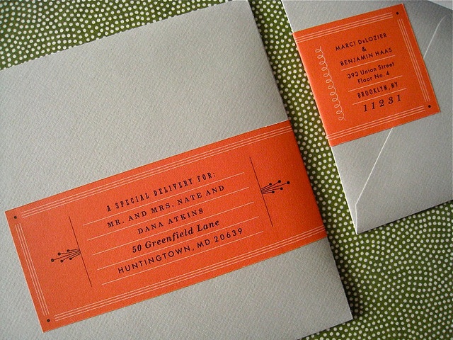 an orange and white ticket sitting on top of a green polka dot covered table cloth