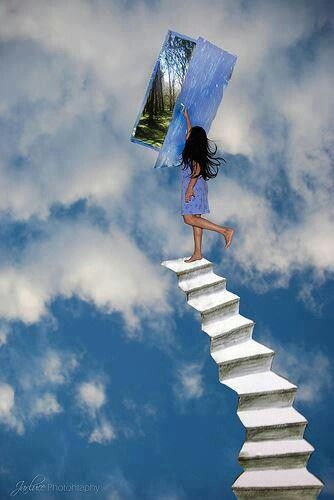 a girl is standing on the top of a stair case with an umbrella over her head