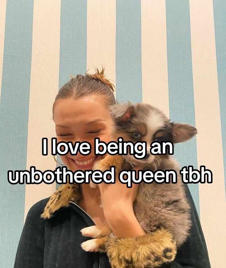 a woman holding a cat with the caption i love being an unbothered queen tbh