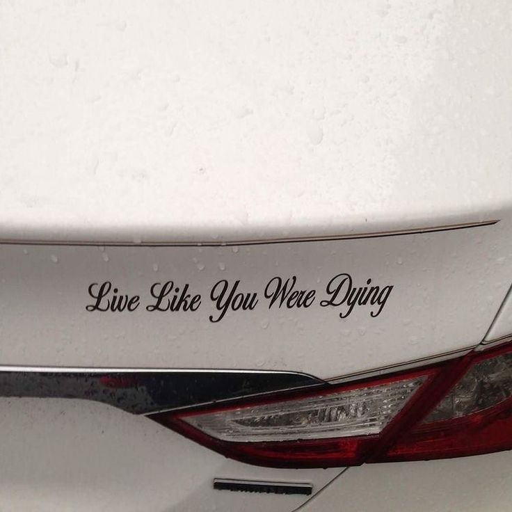 a white car with the words live like you were dying on it