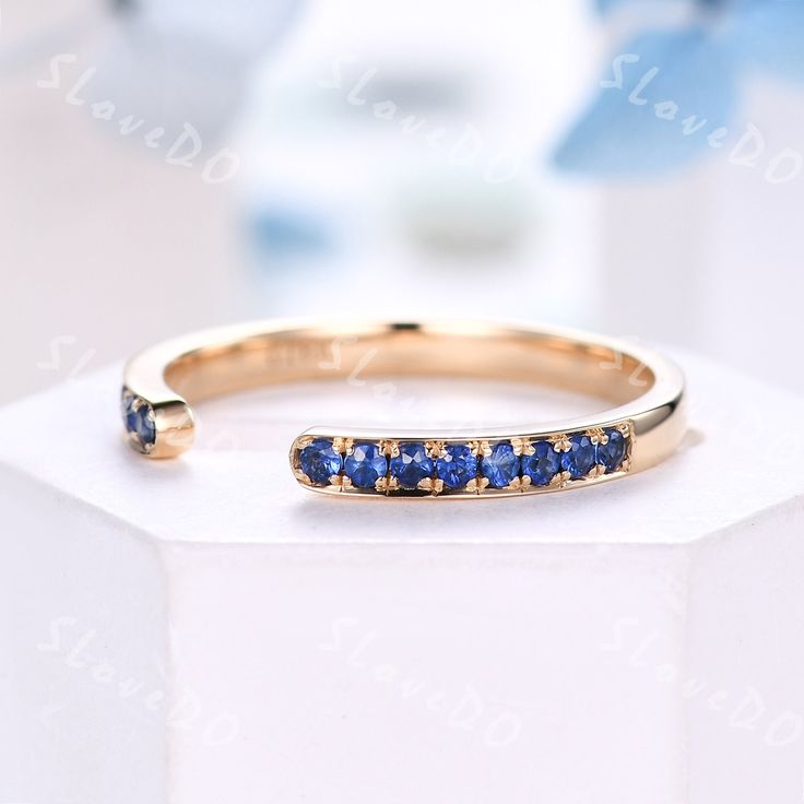 This is an unique sapphire open gap wedding band. A perfect anniversary gift, birthday gift, Stackable matching band. Great as a gift for her. *If you need to match your existing ring and customize the width of the gap, please contact me. Metal *925 sterling silver, white/yellow/rose gold plated *Solid 10k 14k &18k. color:white/yellow/rose gold *Platinum Stone: *Round cut lab created blue sapphire (Please contact me if you would like to change it to natural one)  Band width is approx 1.6mm  Pave setting Custom Order *The main stone can be other gemstones you can imagine,any birthstone can be made.Please contact me if you need this service. *Any size *I can also design the matching band. Other *Rush order *Engraving *Payment plans *Please feel free to contact me if you need the above servic Open Sapphire Birthstone Ring For Anniversary, Sapphire Open Ring Birthstone For Anniversary, Sapphire Birthstone Open Ring For Anniversary, Anniversary Stackable Sapphire Open Ring, Stackable Open Sapphire Ring For Anniversary, Anniversary Stackable Open Sapphire Ring, Sapphire Open Ring For Anniversary, Anniversary Sapphire Open Ring, Gap Ring