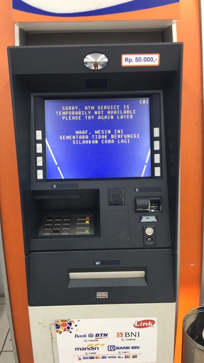 an atm machine with a blue screen on it's front and the words,