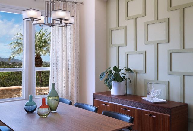 a dining room table with vases on top of it next to a large window