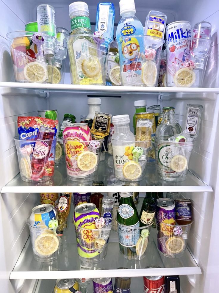 an open refrigerator filled with lots of different types of drinks and snacks on shelves next to each other