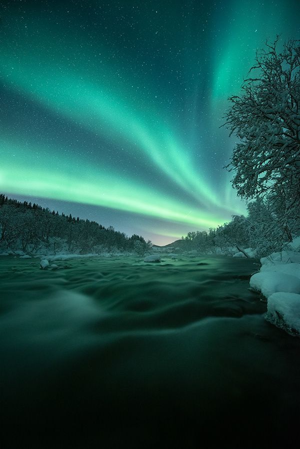 an aurora bore is seen over the water