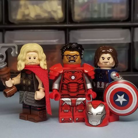 the avengers legos are standing next to each other