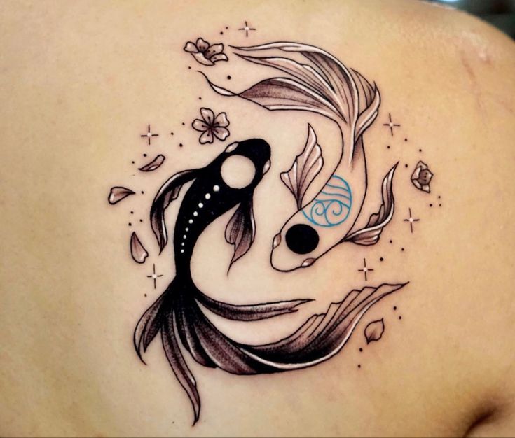 a woman with a tattoo on her back has a fish in it's stomach