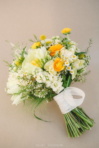 a bridal bouquet with yellow and white flowers