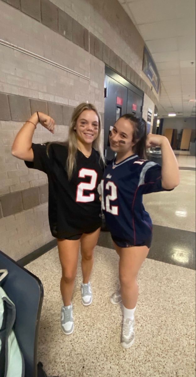 two women in sports uniforms posing for the camera