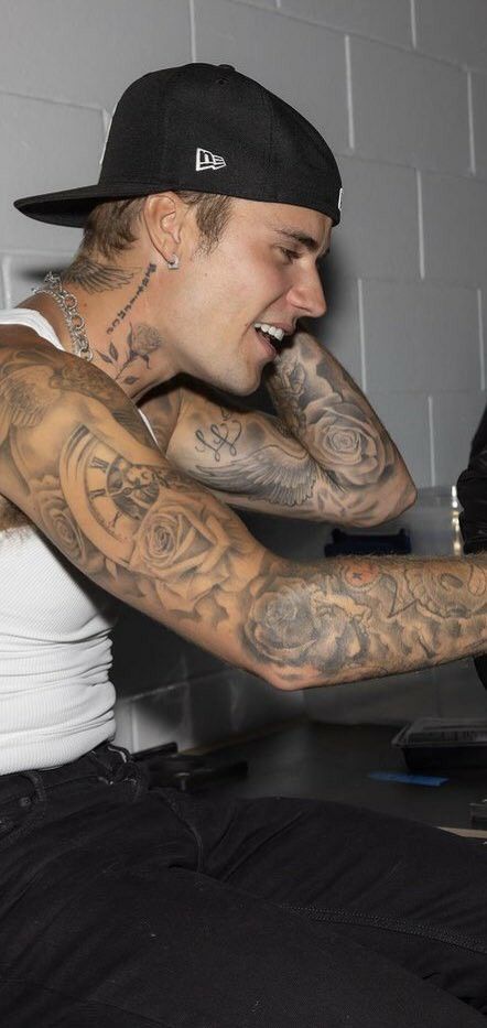 a man with tattoos on his arm and shoulder