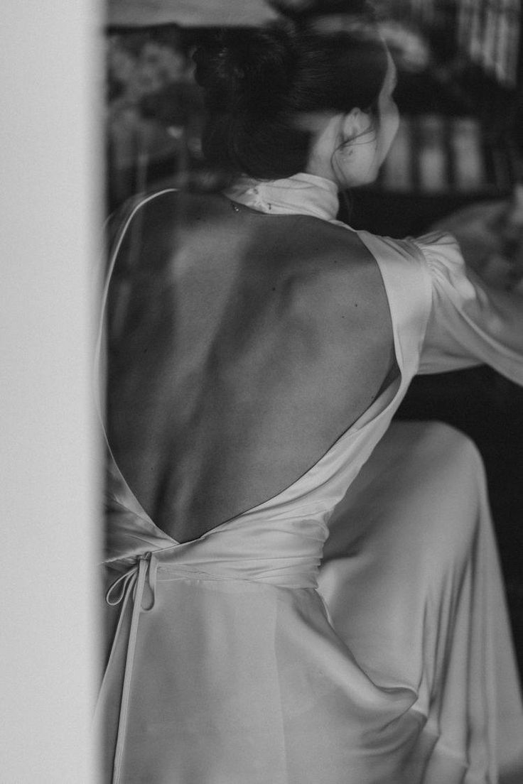 the back of a woman's dress in black and white