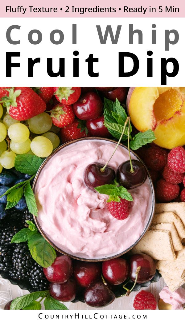 a bowl filled with fruit dip surrounded by fruits and crackers