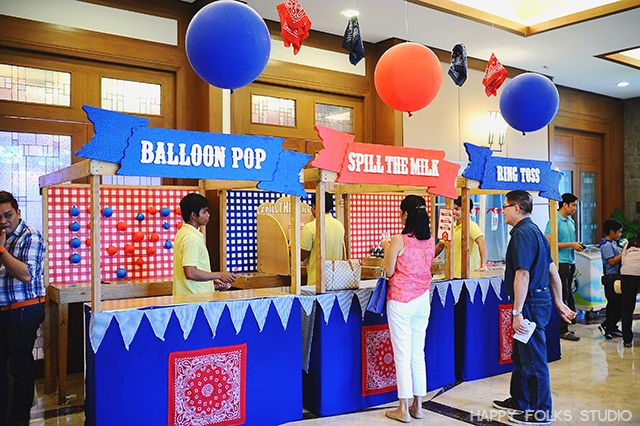 people are standing in line at the balloon pop booth