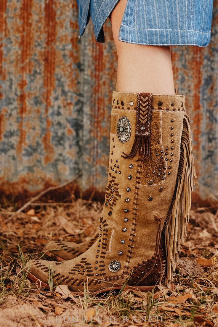 TALK ABOUT SOME SHOWSTOPPERS! These chic kicks have it all: a tall, sexy silhouette, all kinds of studding, conchos galore, and everyone’s favorite – fringe! The warm tan hue and tonal stitching make them ultra-versatile, easy to wear, and pair all year long. Western Boots With Rhinestone Fringe For Fall, Western Rhinestone Fringe Boots For Fall, Brown Fringe Boots For Festival, Festival Leather Fringe Boots, Brown Western Boots With Tassels, Brown Tasseled Boots For Festivals, Bohemian Brown Boots With Tassels, Brown Bohemian Boots With Tassels, Ll Bean Boot