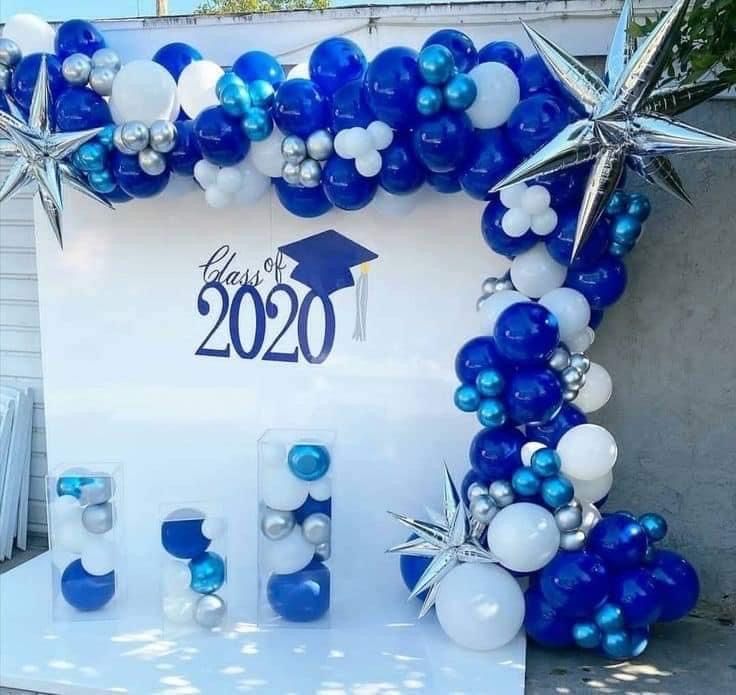 blue and white graduation decorations on display in front of a sign that says class of 2020