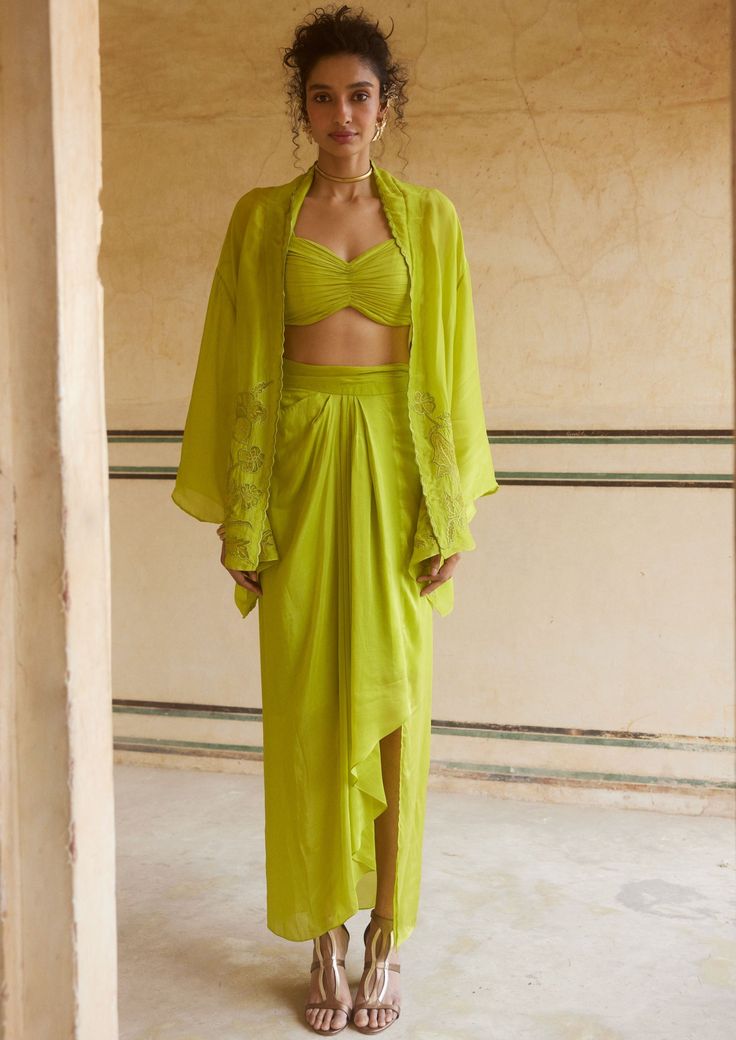 Breezy and romantic fresh lemon yellow cape set is crafted in pure silk organza fabric. The set features beautiful scallop and cutwork details and blouse has draped gathering details and paired with pleating pre draped skirt. Pre-draped Silk Sets, Green Draped Silk Sets, Draped Ruffle Sets For Evening, Draped Ruffles Sets For Evening, Draped Ruffles Evening Set, Draped Silk Sets For Summer, Green Draped Party Sets, Elegant Green Sets With Cape Sleeves, Fitted Draped Sets For Spring