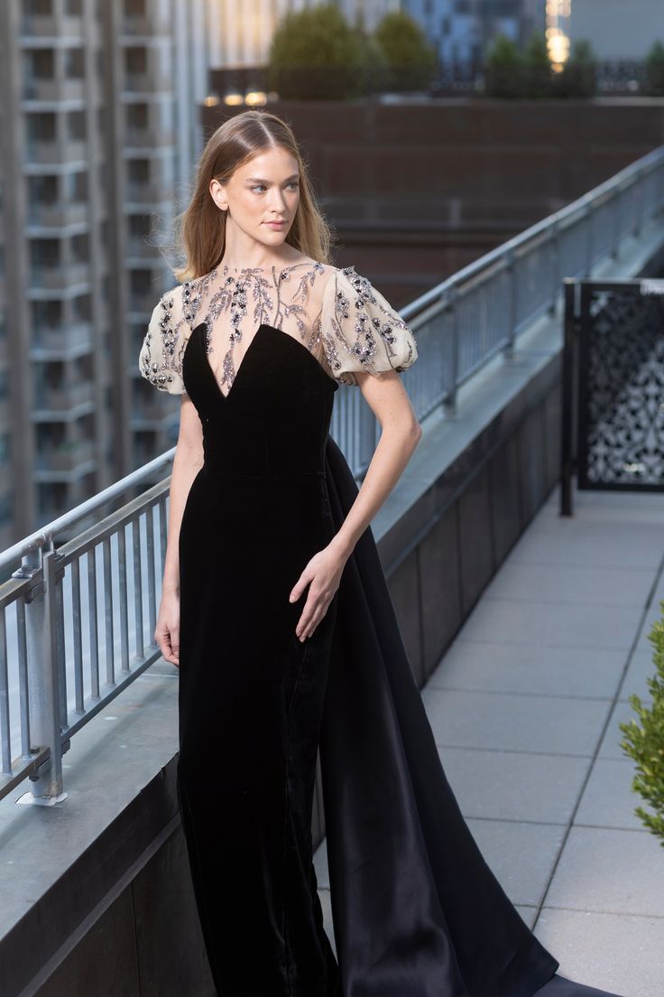 Deep V neck pointed bodice velvet collumn gown with organza train and embroidered tulle puff sleeve Tulle Dress Ideas, Black Gown With Sleeves, A Cut Dress, Black And White Evening Dress, Deep V Gown, Opera Gown, Velvet Dresses Outfit, Winter Gowns, Chic Dress Classy