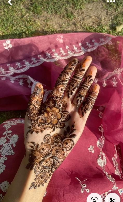 henna tattoo on the palm of a woman's hand