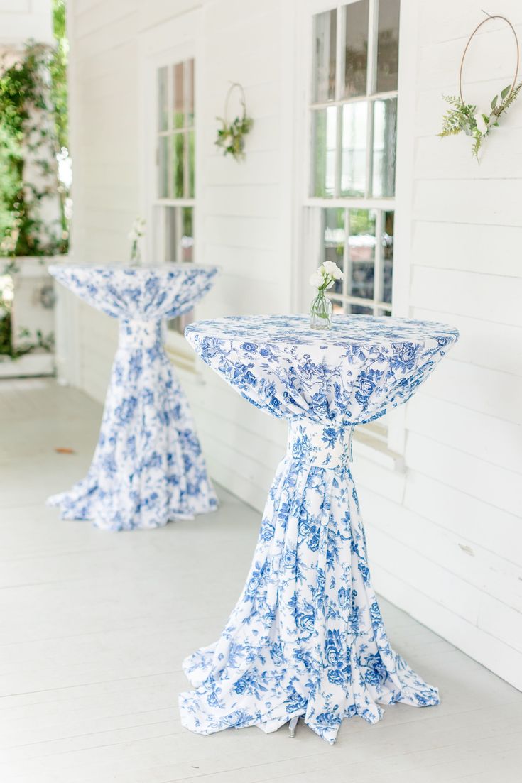 two blue and white pedestals sitting on the side of a building