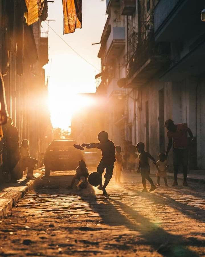 children playing in the street at sunset