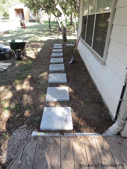 steps leading up to the front door of a house with trees in the back yard