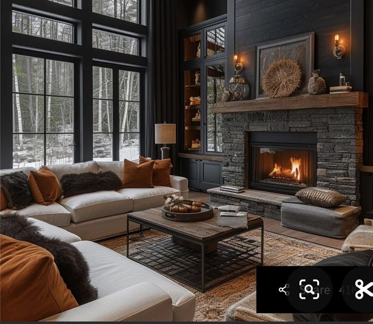 a living room filled with furniture and a fire place in front of a large window