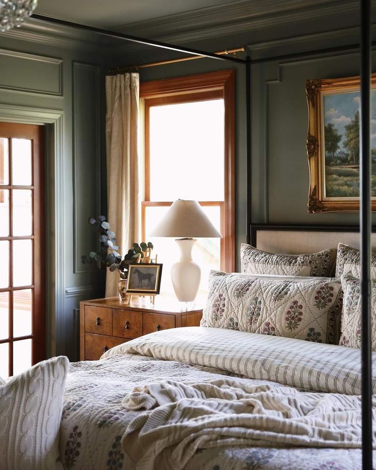 a bedroom with a four poster bed and two lamps on either side of the bed